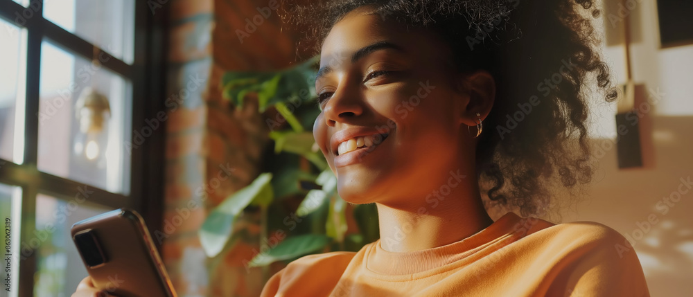 Young curly-haired brunette girl smiling using smartphone indoors near window. Generative AI. Young curly-haired brunette girl smiling using smartphone indoors near window. Generative AI.