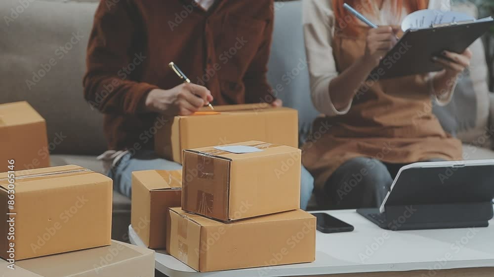 Young couple relaxing sitting on the sofa using the computer laptop around cardboard boxes, very happy moving to a new house. Young couple relaxing sitting on the sofa using the computer laptop around cardboard boxes, very happy moving to a new house.
