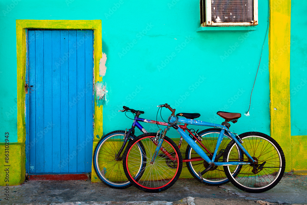 Two old bicycles parked against a colorful home in Isla Mujeres, Mexico
Two old bicycles parked against a colorful home in Isla Mujeres, Mexico