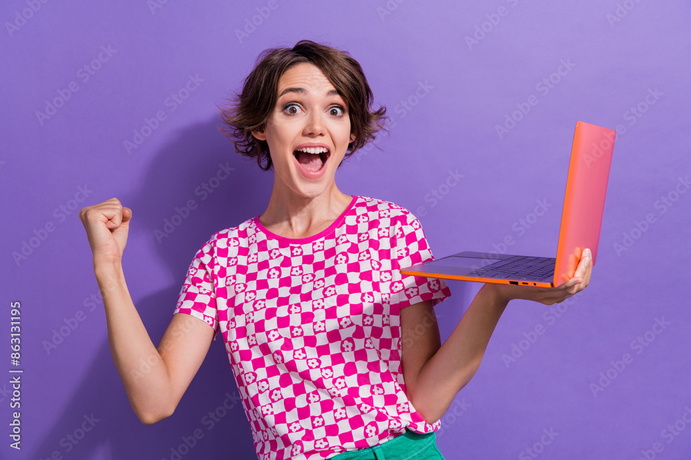 Photo of glad ecstatic crazy cheerful girl wear trendy clothes buy macbook hand fist scream hooray isolated on purple color background Photo of glad ecstatic crazy cheerful girl wear trendy clothes buy macbook hand fist scream hooray isolated on purple color background