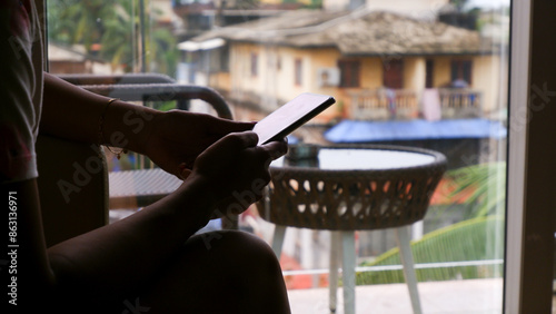 Lady is typing on smart phone, looks like something serious matter.