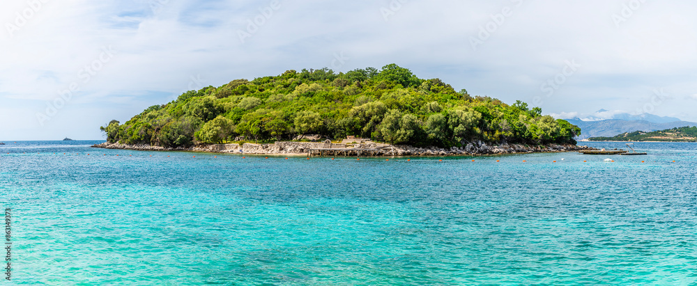 Naklejka premium A close up view towards an island offshore from the beach at Ksamil, Albania in summertime