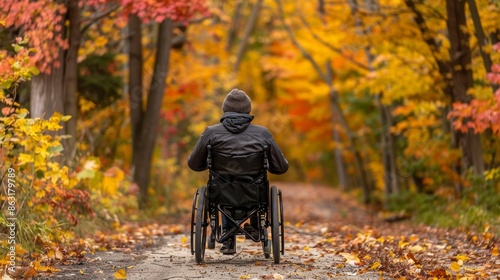 Inclusive Autumn Bike Ride: Wheelchair Accessible Trail Surrounded by Vibrant Fall Foliage © spyrakot