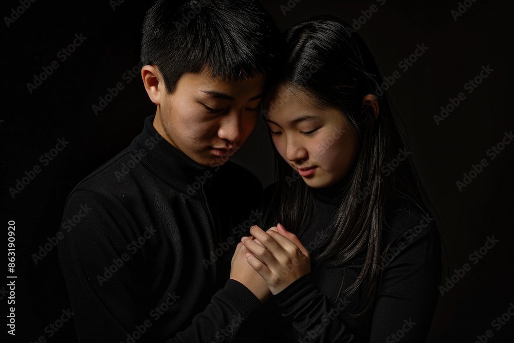 A pair of adults standing side by side, possibly in an intimate moment A pair of adults standing side by side, possibly in an intimate moment