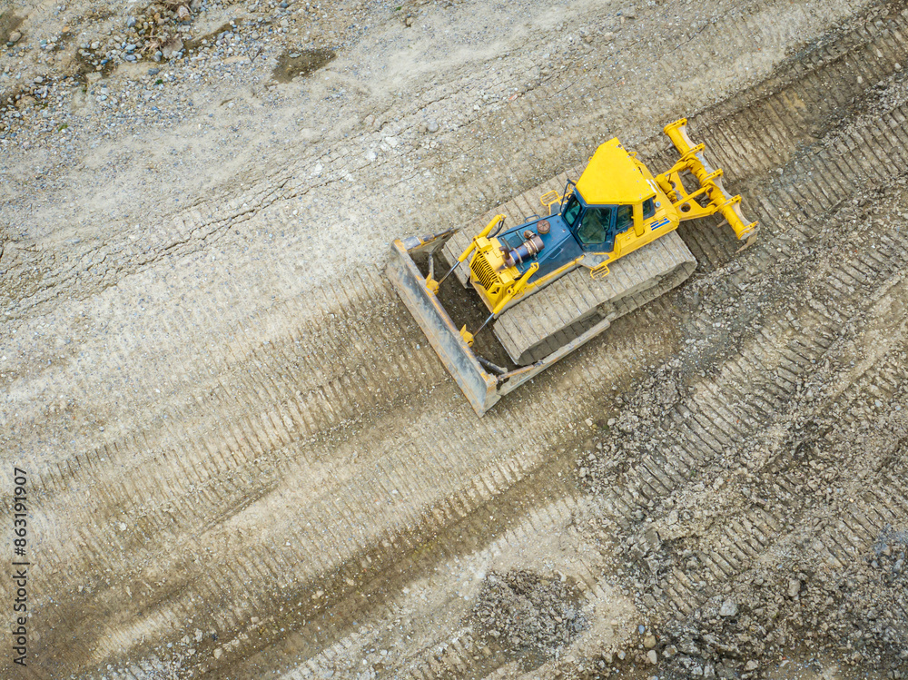 Aerial view of bulldozer working in mine. Heavy machinery for earth moving. Aerial view of bulldozer working in mine. Heavy machinery for earth moving.