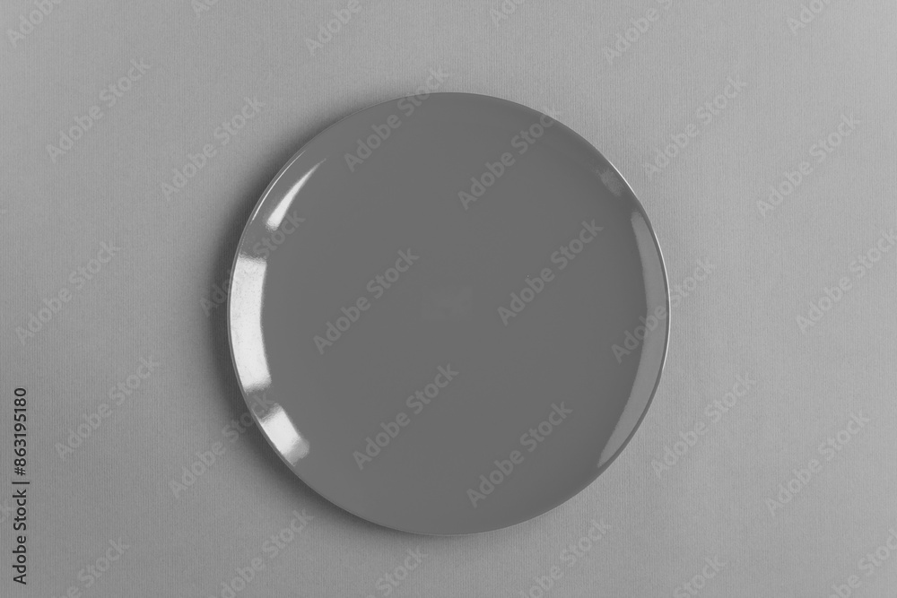 Empty gray plate on the gray background. Top view. Copy space. Close-up. Empty gray plate on the gray background. Top view. Copy space. Close-up.