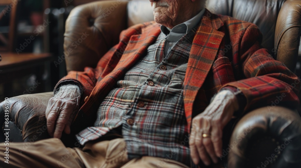 A senior gentleman sitting comfortably in his chair, dressed in a hat A senior gentleman sitting comfortably in his chair, dressed in a hat