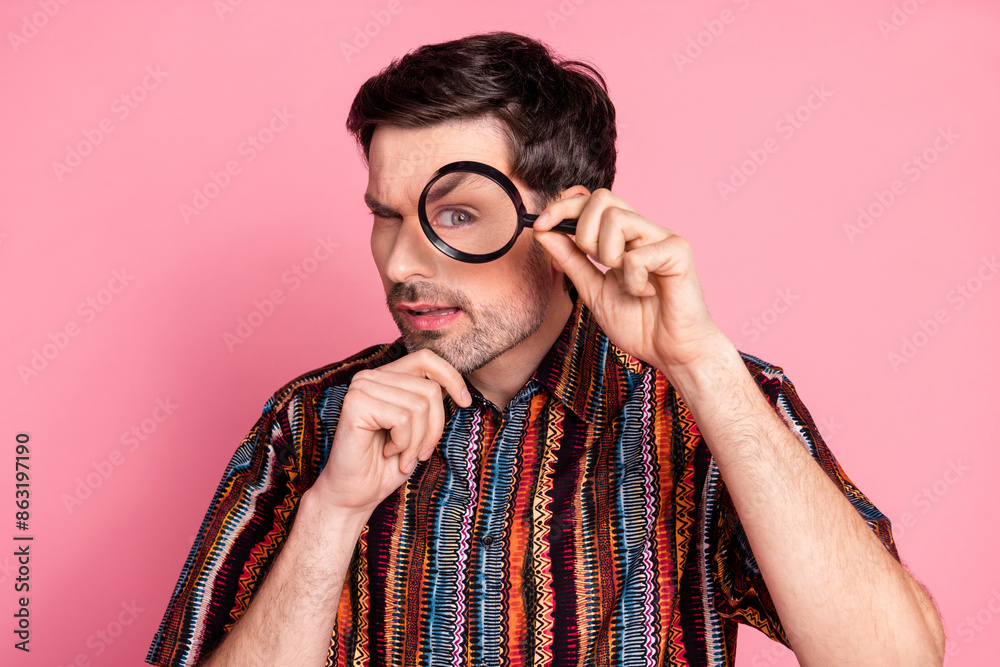 Portrait of nice young man magnifier lens glass wear shirt isolated on pink color background Portrait of nice young man magnifier lens glass wear shirt isolated on pink color background