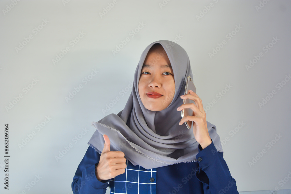 Portrait of an Asian woman making a video call on a white background Portrait of an Asian woman making a video call on a white background