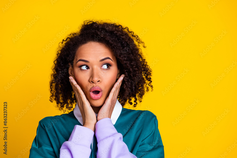 Photo of impressed woman with perming coiffure dressed stylish shirt look at offer empty space isolated on yellow color background