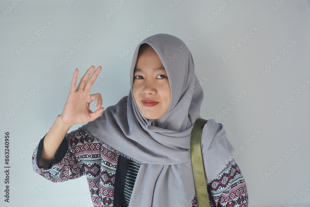 Portrait of a pretty cheerful casual asian girl carrying backpack standing isolated over white background Portrait of a pretty cheerful casual asian girl carrying backpack standing isolated over white background