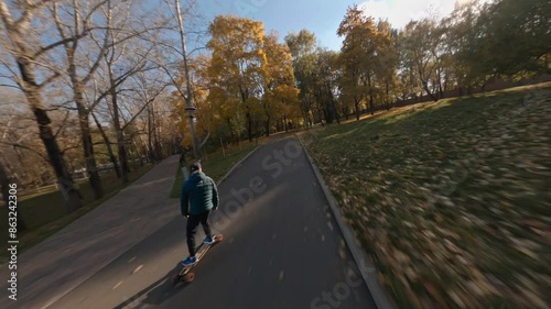 Wallpaper Mural A guy on a skateboard rides through an autumn park Torontodigital.ca