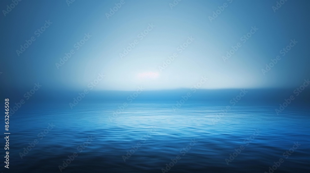 Obraz premium A serene blue ocean with a hazy sky and gentle waves.