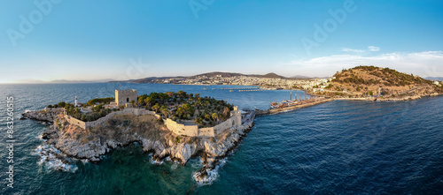 Fototapeta Naklejka Na Ścianę i Meble -  Kusadasi, Aydin, Turkey. Guvercinada Island (Pigeon Island) and Guvercinada Castle with Kusadasi city background. Kusadasi is a popular tourist destination in Turkey. Drone shot.