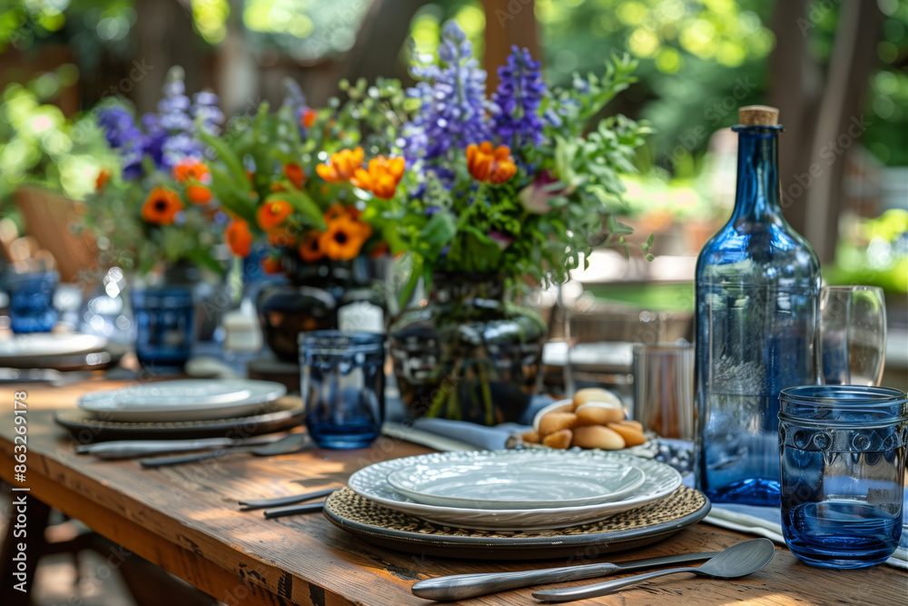 Table set for outdoor summer dinner party with blue and white decorations. Plates filled with Russian salad, wood farmhouse style tables. American flag backdrop. Table set for outdoor summer dinner party with blue and white decorations. Plates filled with Russian salad, wood farmhouse style tables. American flag backdrop.