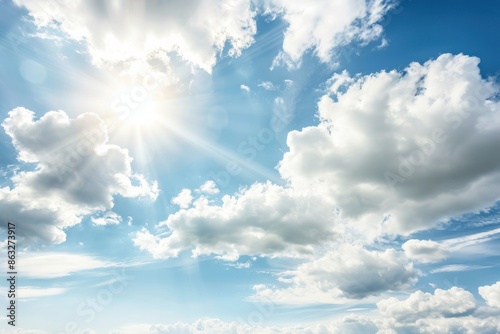 A bright daytime sky with scattered, fluffy white clouds and the sun shining intensely, casting rays through the clouds.