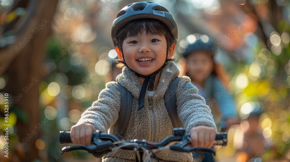 Boy in Safety Helmet Cycling on Pathway with Family Behind Boy in Safety Helmet Cycling on Pathway with Family Behind
