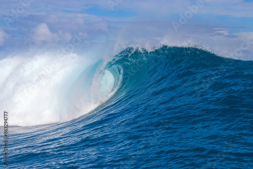 Monster waves at Teahupoo, Tahiti, French Polynesia - a world famous spot for surfing championships. The village of Teahupoo is known as “The end of the road” because the road from Papeete ends there.