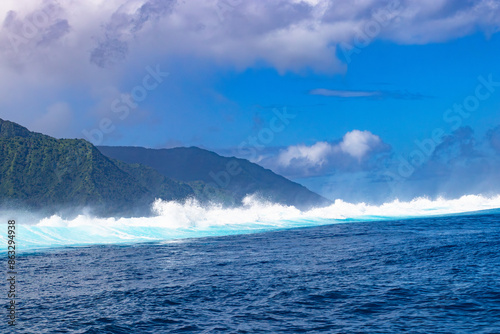 Monster waves at Teahupoo, Tahiti, French Polynesia - a world famous spot for surfing championships. The village of Teahupoo is known as “The end of the road” because the road from Papeete ends there.
