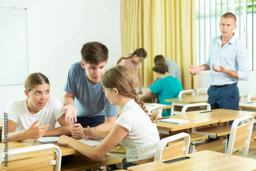 Fellow students having group work tasks during school day