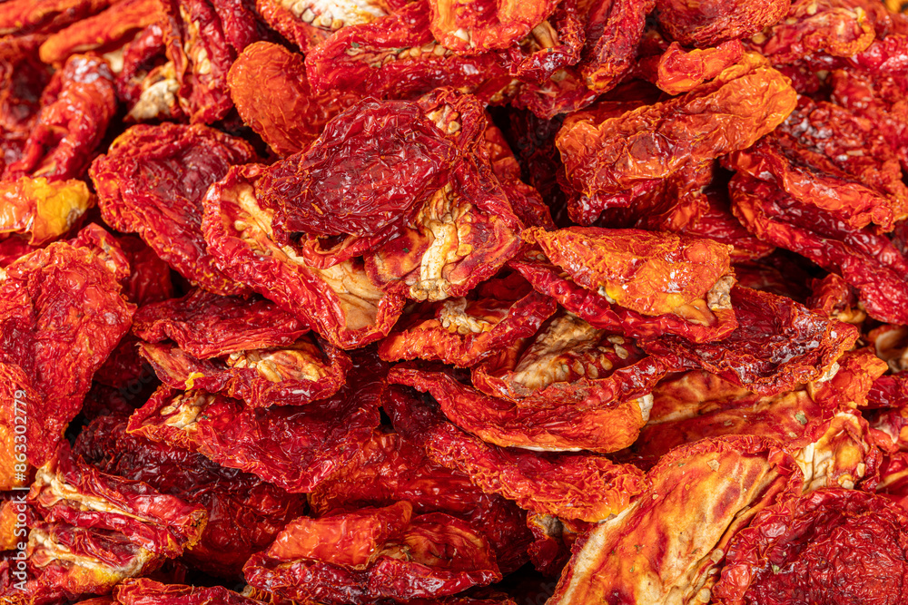 Sun dried tomatoes, dried red and yellow cherry tomatoes, close up, top view. Sun dried tomato background. Dried dehydrated tomato chips. Healthy eating concept. Sun dried tomatoes, dried red and yellow cherry tomatoes, close up, top view. Sun dried tomato background. Dried dehydrated tomato chips. Healthy eating concept.