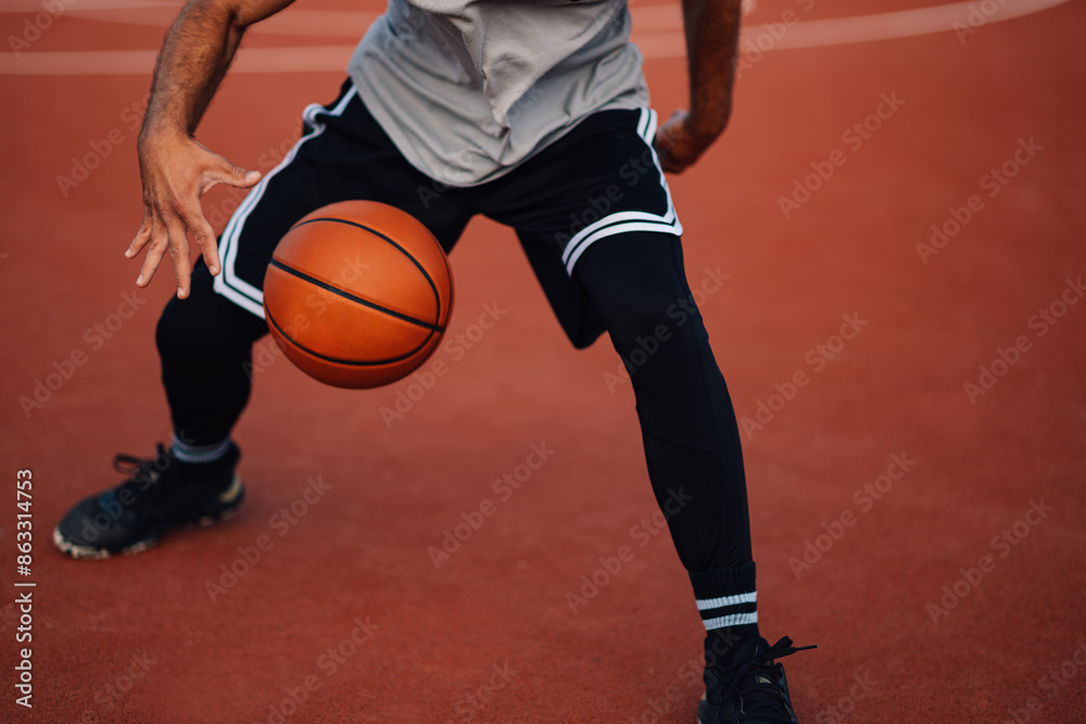 Player handling a basketball on a court Player handling a basketball on a court