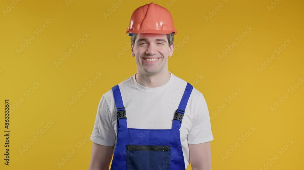 Friendly handyman showing yes signal, nods head,approve.Positive smiling builder Friendly handyman showing yes signal, nods head,approve.Positive smiling builder