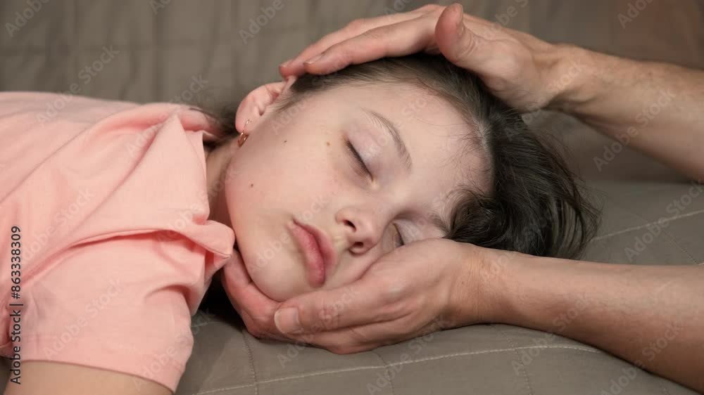 Take careful child head. A woman carefully takes the sick sleepy daughter head on the sofa. Take careful child head. A woman carefully takes the sick sleepy daughter head on the sofa.