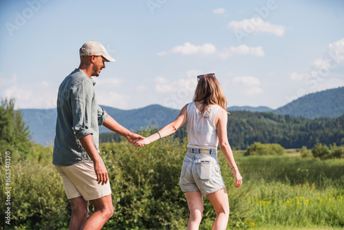 Εκτύπωση καμβά Cheerful couple on a summer lake vacation, going on a canoe ride