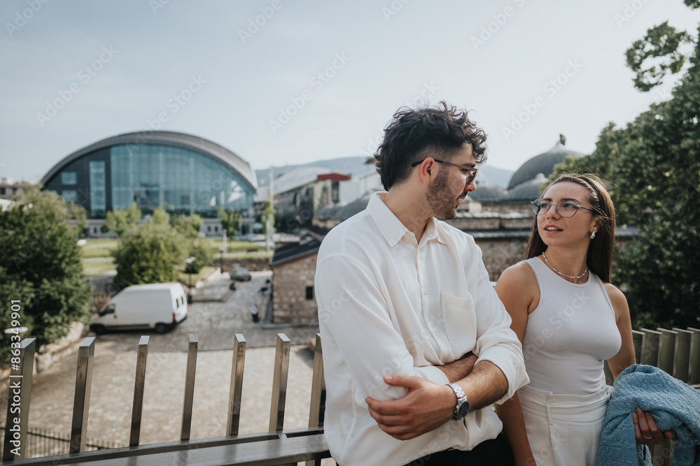 Two business colleagues having a casual conversation outdoors in a modern urban setting with buildings in the background. Two business colleagues having a casual conversation outdoors in a modern urban setting with buildings in the background.