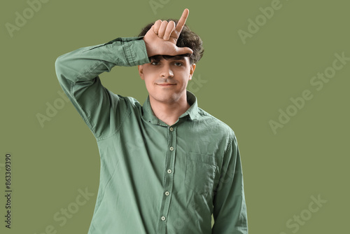 Young man showing loser ges...