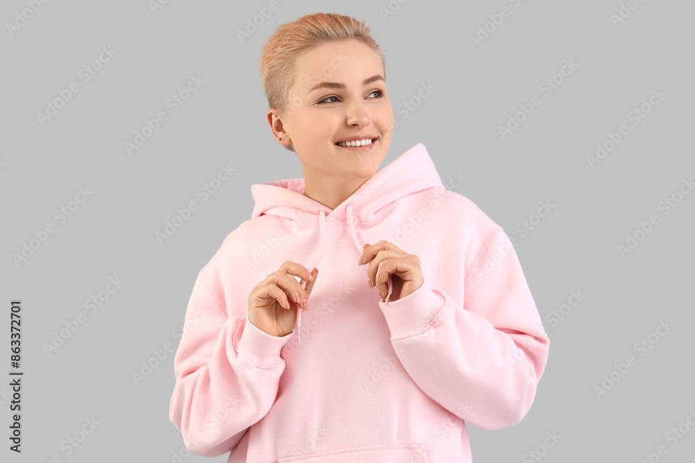 Young woman with short hair on grey background Young woman with short hair on grey background