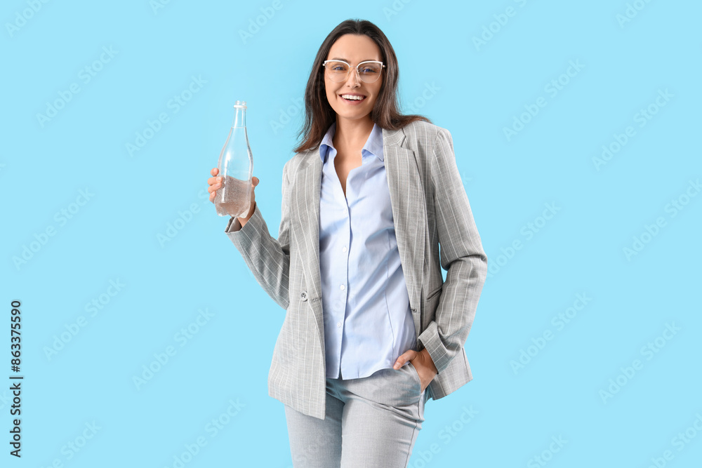 Young businesswoman with bottle of water on color background Young businesswoman with bottle of water on color background