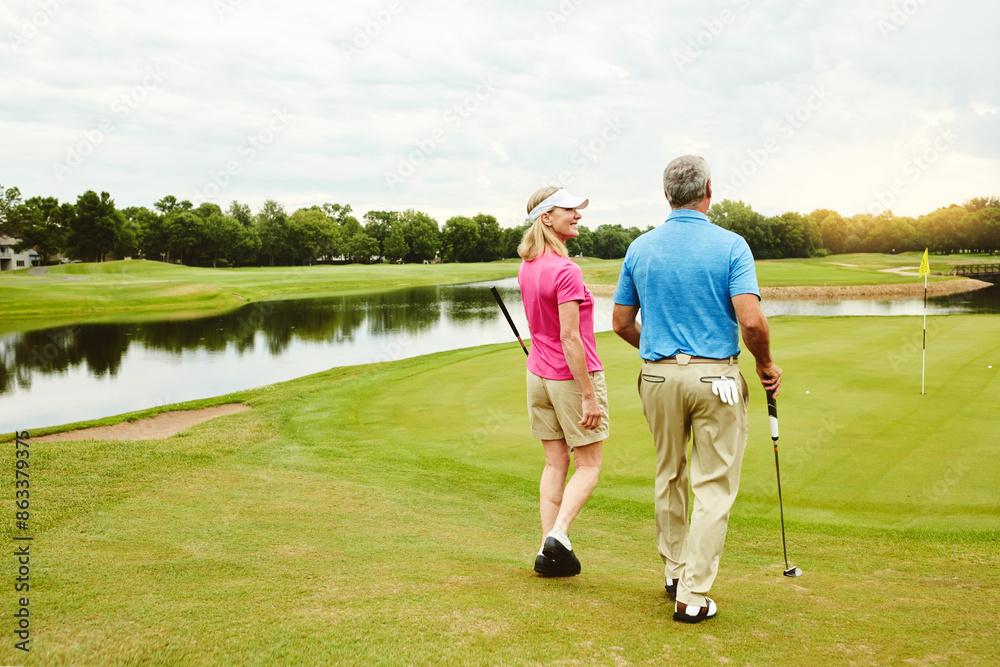 Outdoor, mature and couple walking on golf course for conversation, game advice and end of hole match practice. Bonding, woman and man talking with golfer club, location and recreation competition Outdoor, mature and couple walking on golf course for conversation, game advice and end of hole match practice. Bonding, woman and man talking with golfer club, location and recreation competition