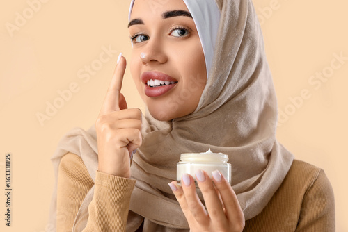 Young Muslim woman applying...
