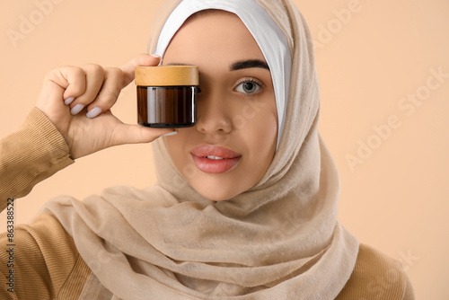 Young Muslim woman with jar...