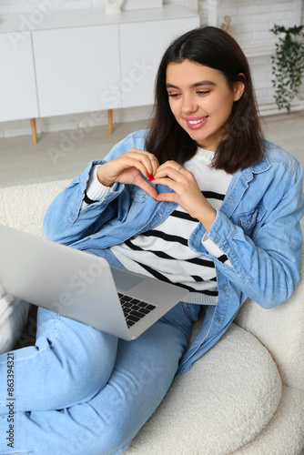 Young woman with laptop mak...