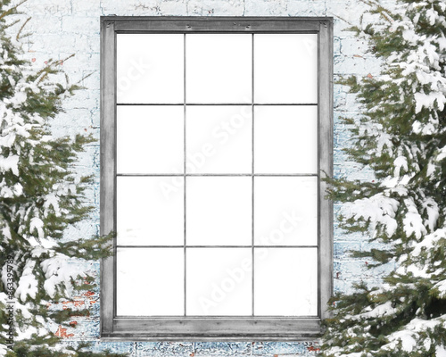 A winter scene of the outside of a house looking into the inside of a blank home with trees. Add your portrait into the cutout copyspace area for a creative holiday portrait idea. photo