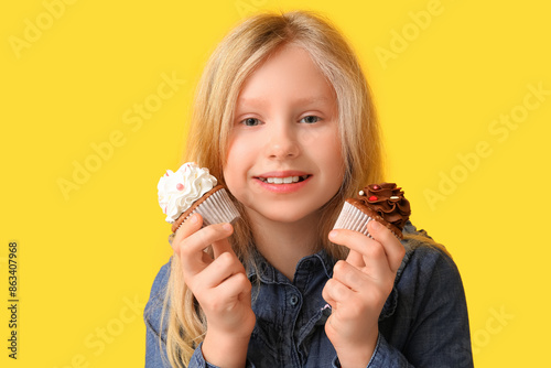Cute little girl holding cu...