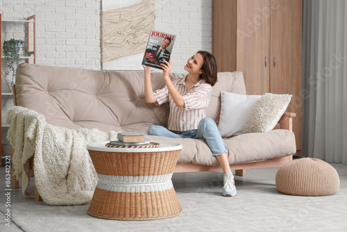 Young pretty woman reading ...