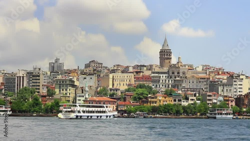 Galata Tower at Golden Horn, Istanbul. Public passenger boat arrives to Karakoy port in Istanbul.  photo