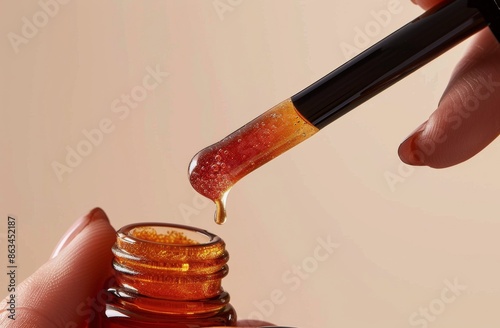 Dropper Dispensing Amber Liquid Into Bottle