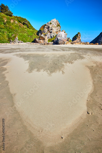 Rugged Rocks and Heart-Shaped Sand at Harris Beach Low Perspective photo