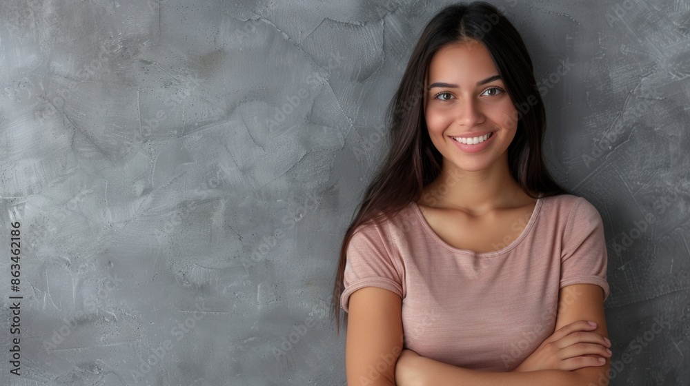 A young Latina woman smiles confidently with her arms crossed, standing in front of a grey wall. Generative AI A young Latina woman smiles confidently with her arms crossed, standing in front of a grey wall. Generative AI