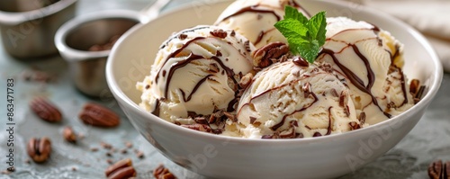 Vanilla Ice Cream With Chocolate Sauce, Pecans, and Mint Garnish
