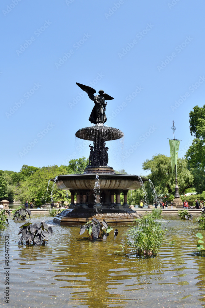 New York, USA - May 18 2023: Vertical View of a large fountain with a statue of an angel on top. The fountain is located in central park New York, USA - May 18 2023: Vertical View of a large fountain with a statue of an angel on top. The fountain is located in central park