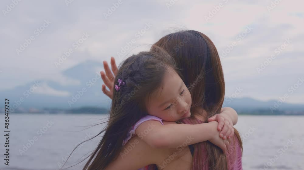 Asian mother holding adorable kid daughter while walking at Fuji mountain. Asian mother holding adorable kid daughter while walking at Fuji mountain.