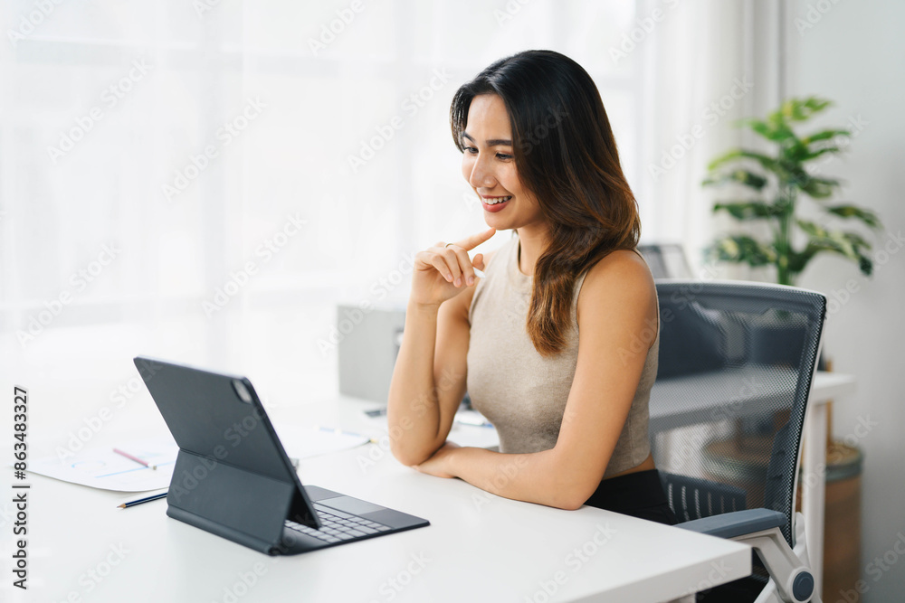 Confident Asian Business Woman Working on Tablet in Modern Office Setting Confident Asian Business Woman Working on Tablet in Modern Office Setting