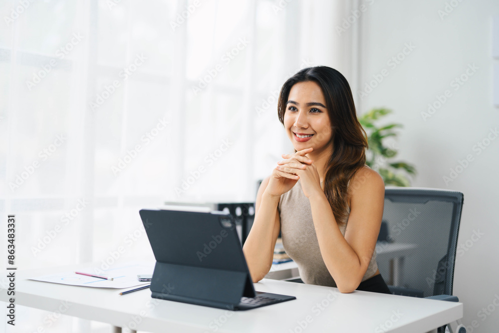 Confident Asian Business Woman Working on Tablet in Modern Office Setting Confident Asian Business Woman Working on Tablet in Modern Office Setting