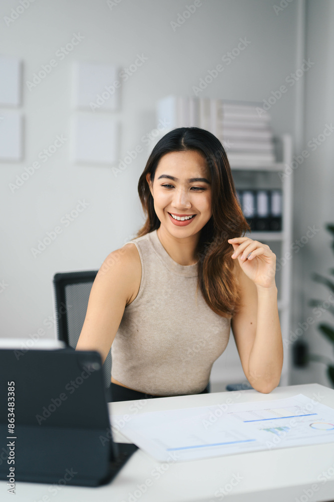 Confident Asian Business Woman Working on Laptop in Modern Office Setting, Smiling and Engaged in Professional Work Confident Asian Business Woman Working on Laptop in Modern Office Setting, Smiling and Engaged in Professional Work